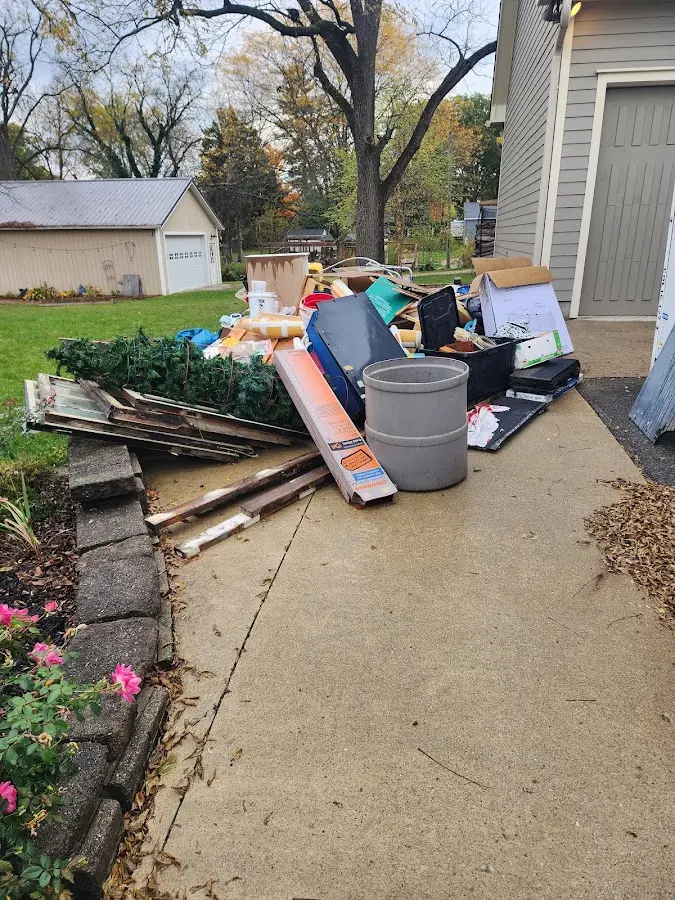 Dumpster being loaded with debris for Demolition Dumpster Rental in Forsyth